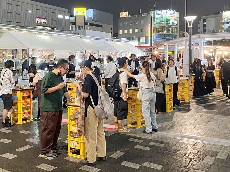 ビールや料理を楽しむ来場者＝20日夕、さいたま市浦和区のJR浦和駅東口駅前市民広場