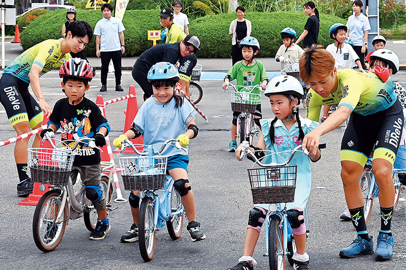 さいたまディレーブの選手から自転車の乗り方を学ぶ児童たち＝埼玉県さいたま市中央区役所