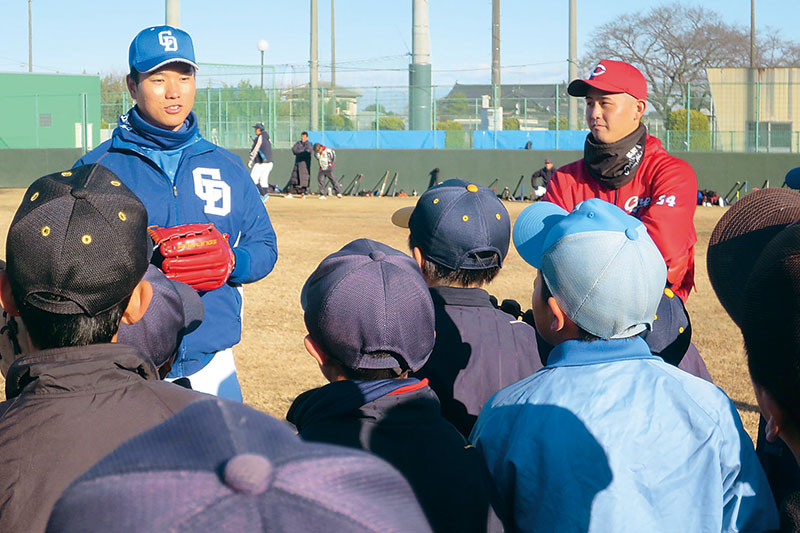 子どもたちを指導する清水達也投手（左）と高橋昂也投手＝15日午前、加須市の加須きずなスタジアム