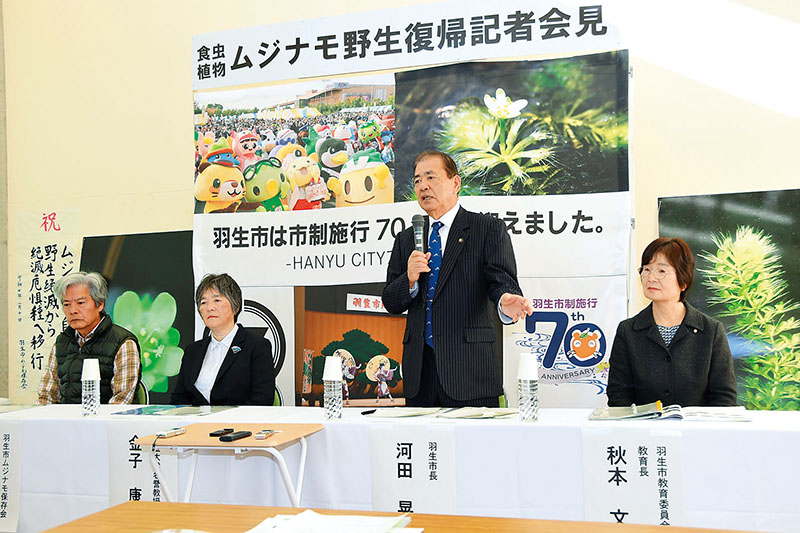 ムジナモの野生復帰を受け、会見で喜びを語る羽生市の河田晃明市長（右から2人目）ら関係者