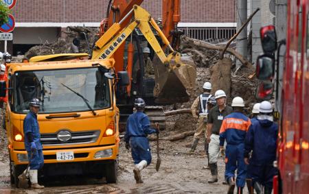 土砂崩れ現場付近で続く、流木などの除去作業＝１３日午前９時１７分、松山市