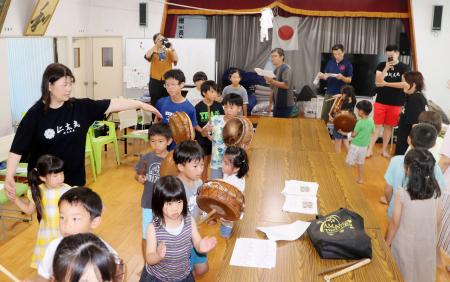 伝統舞踊の「八月踊り」で交流する神戸市の保育園児らと鹿児島県大和村名音集落の児童ら＝２７日、大和村