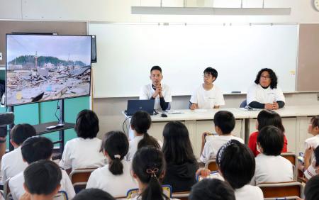 東日本大震災で大きな津波に見舞われた岩手県宮古市を訪れ、市立宮古小で講演する石川県珠洲市の真脇魁さん（奥左）ら＝１０日午後