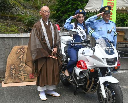 白バイと記念撮影する本瀧寺の野間秀顕副住職（左）ら＝１６日午前、大阪府能勢町