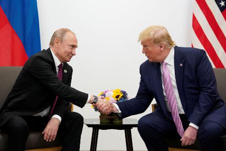 ２０１９年６月、大阪で会談した際に握手するロシアのプーチン大統領（左）とトランプ米大統領（ロイター＝共同）