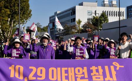 ２６日、ソウルの韓国大統領府近くで声を上げる梨泰院雑踏事故の遺族ら（共同）