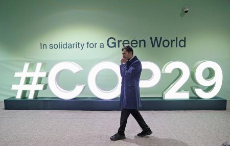 ＣＯＰ２９の会場を歩く男性＝８日、アゼルバイジャン・バクー（ロイター＝共同）