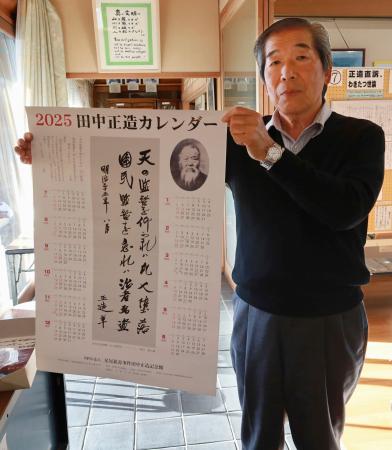 復活販売された田中正造の言葉を記したカレンダーを持つ島野薫さん＝２１日、群馬県館林市