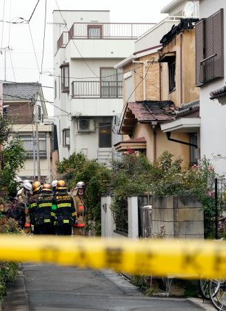 住宅火災のあった現場付近に集まる消防隊員ら＝１３日午前１０時５２分、東京都江戸川区